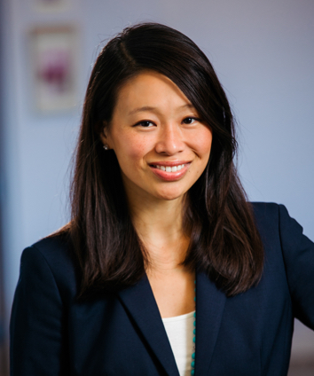 Sara McDonough smiling Team Headshot with hand on hip