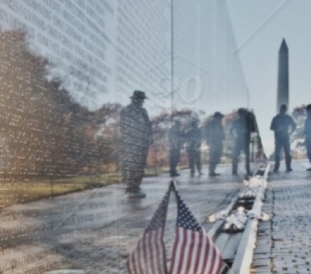 Washington DC Vietnam wall with names and American Flag with Washington Monument in background