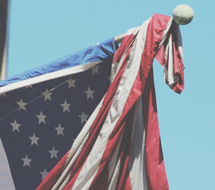 American flag draped over flag pole