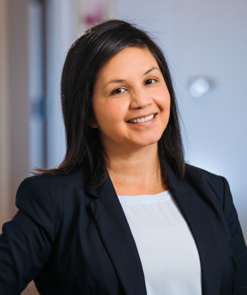 Sandra Valiente Smiling Team Headshot with hand on hip
